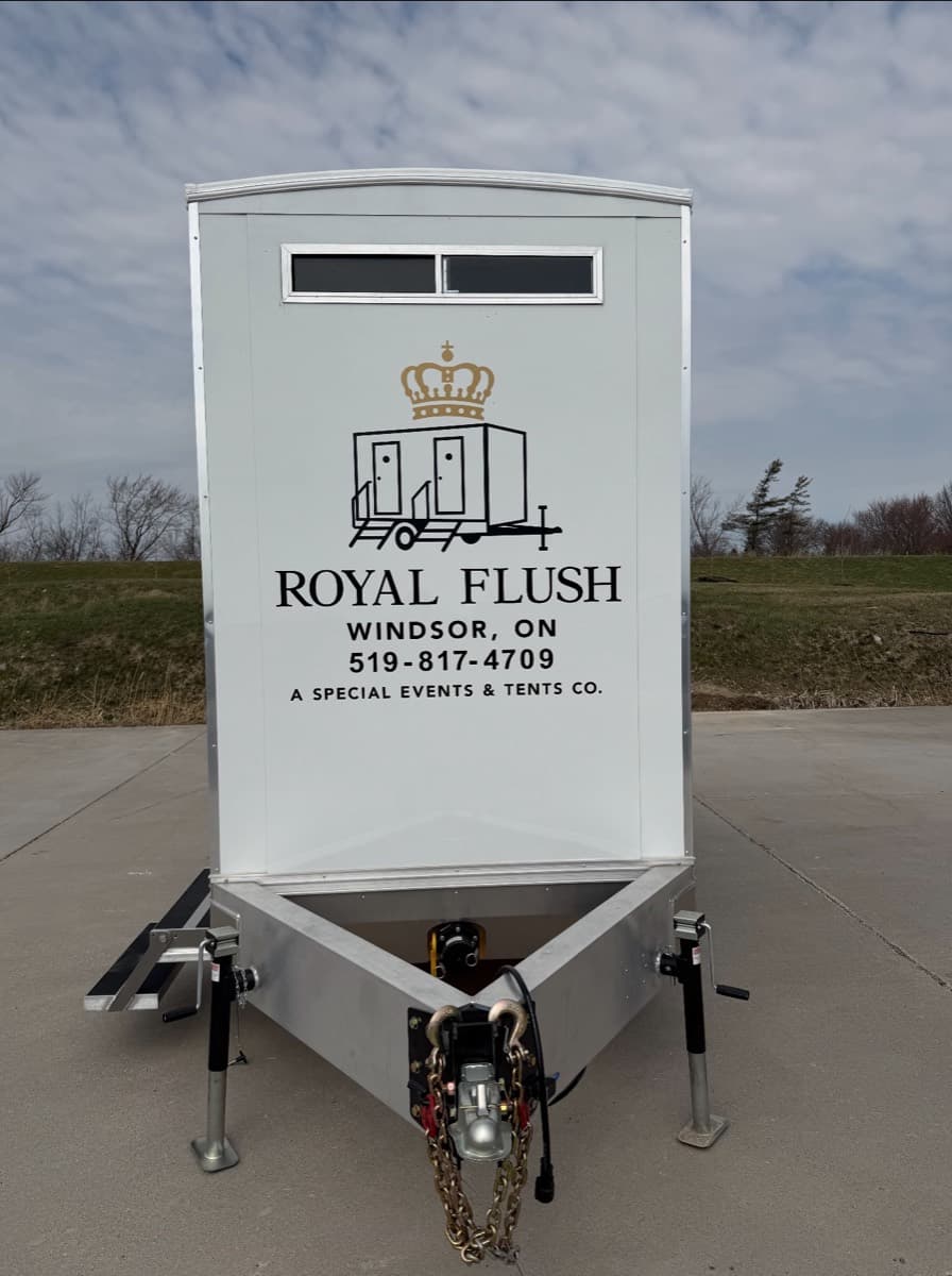 Front view of the Royal Flush Windsor restroom trailer displaying the branded logo and phone number